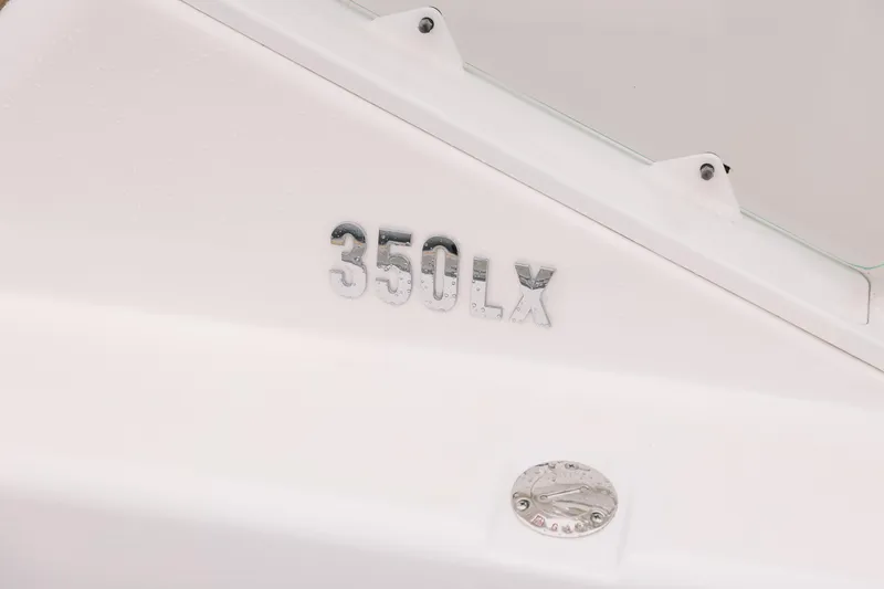  Yacht Photos Pics Close-up of 2010 Everglades 350LX boat model nameplate on white surface.