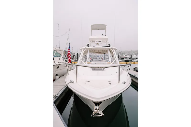 Yacht Photos Pics 2010 Everglades 350LX boat docked in a marina, front view with American flag.