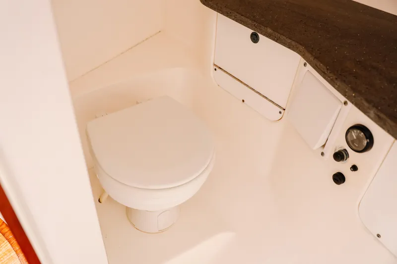  Yacht Photos Pics 2010 Everglades 350LX boat interior bathroom with toilet and storage compartments.
