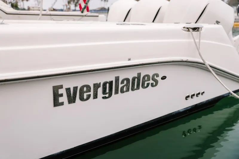  Yacht Photos Pics 2010 Everglades 350LX boat side view with logo, docked on calm water.