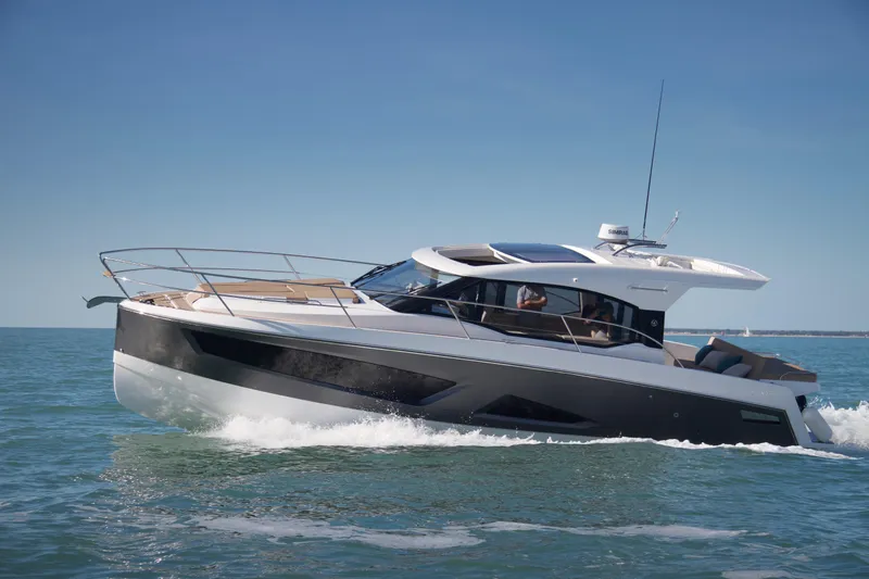  Yacht Photos Pics 2025 Skamander Monaco Coupe yacht cruising on open water under clear blue skies.