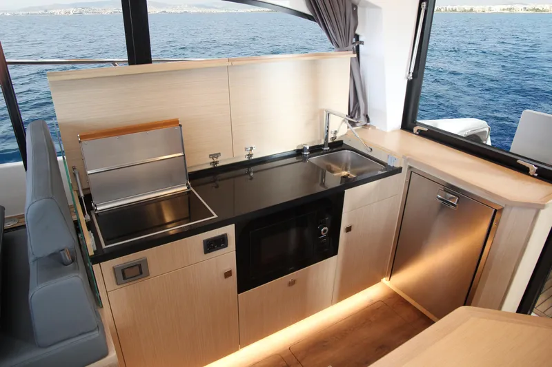  Yacht Photos Pics Modern kitchen interior in 2025 Skamander Monaco Coupe yacht, featuring sleek appliances and ocean view.