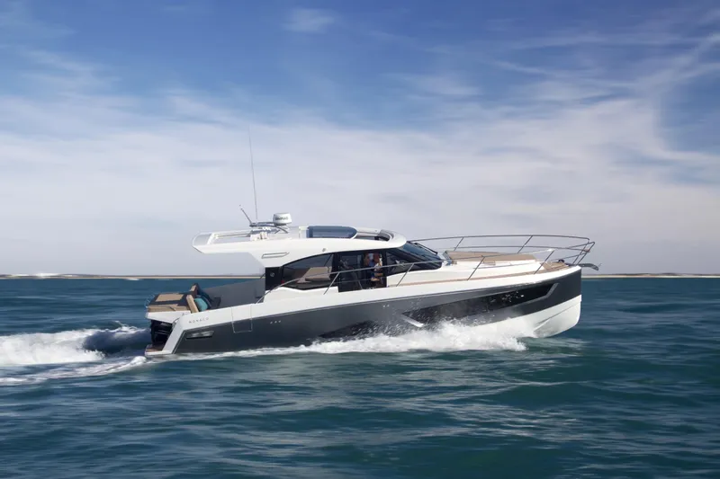  Yacht Photos Pics 2025 Skamander Monaco Coupe yacht cruising on open water under a clear sky.