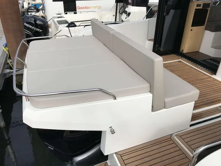  Yacht Photos Pics 2025 Skamander Monaco Coupe boat with cushioned seating and wooden deck.