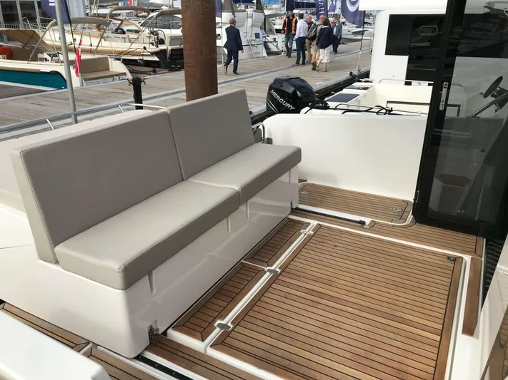  Yacht Photos Pics 2025 Skamander Monaco Coupe yacht with sleek seating and teak deck at a marina.