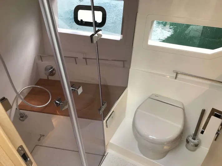  Yacht Photos Pics 2025 Skamander Monaco Coupe bathroom with shower, toilet, and window view.