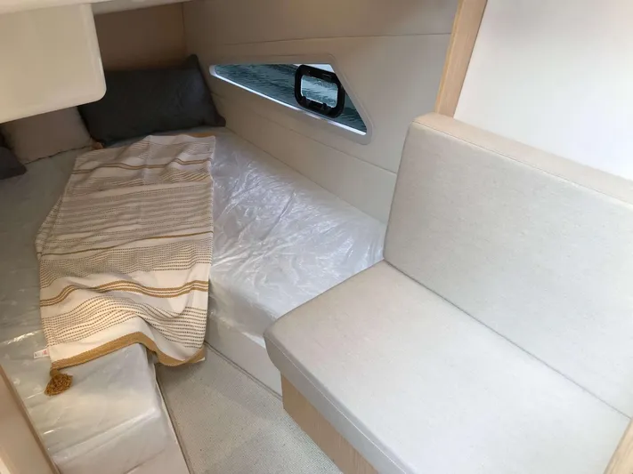  Yacht Photos Pics Interior cabin of 2025 Skamander Monaco Coupe with cozy bed and seating area.