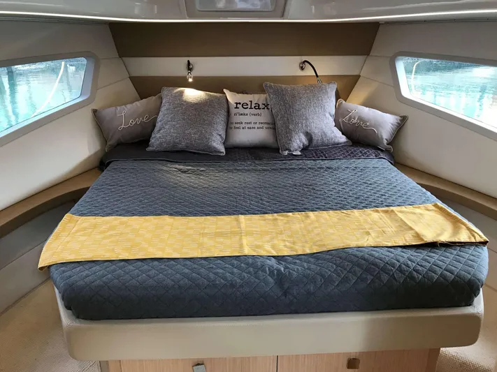  Yacht Photos Pics Luxurious bedroom interior of 2025 Skamander Monaco Coupe yacht with cozy bedding and pillows.