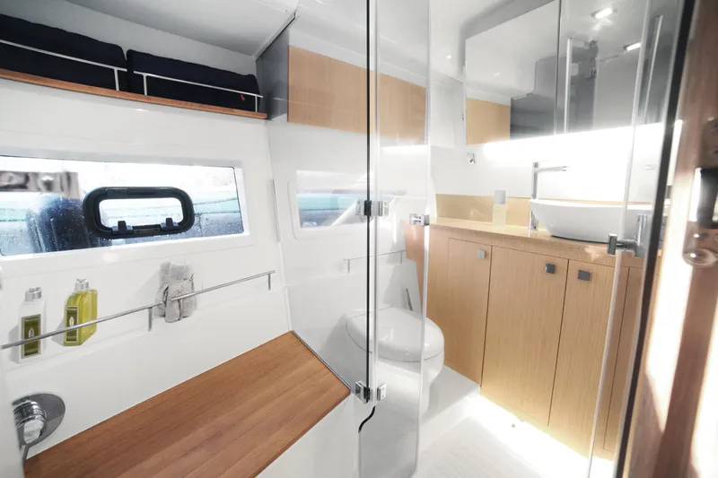  Yacht Photos Pics Luxurious bathroom interior of 2025 Skamander Monaco Coupe with modern fixtures and wooden accents.