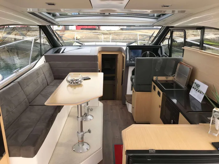  Yacht Photos Pics Luxurious interior of 2025 Skamander Monaco Coupe yacht with modern seating and dining area.