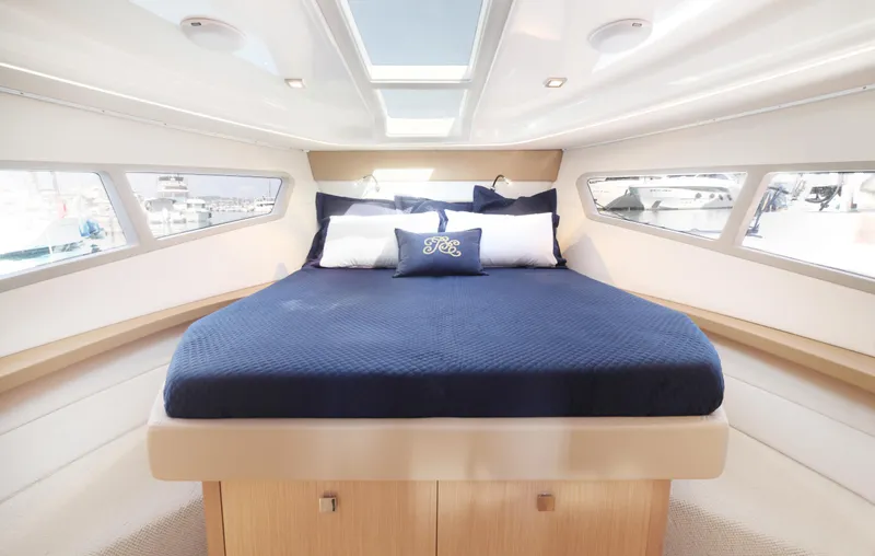  Yacht Photos Pics Luxurious cabin interior of 2025 Skamander Monaco Coupe yacht with elegant bedding.