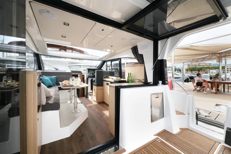  Yacht Photos Pics Luxurious interior of 2025 Skamander Monaco Coupe yacht with elegant dining area and modern design.