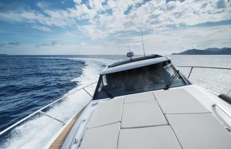  Yacht Photos Pics 2025 Skamander Monaco Coupe yacht cruising on open sea under a partly cloudy sky.