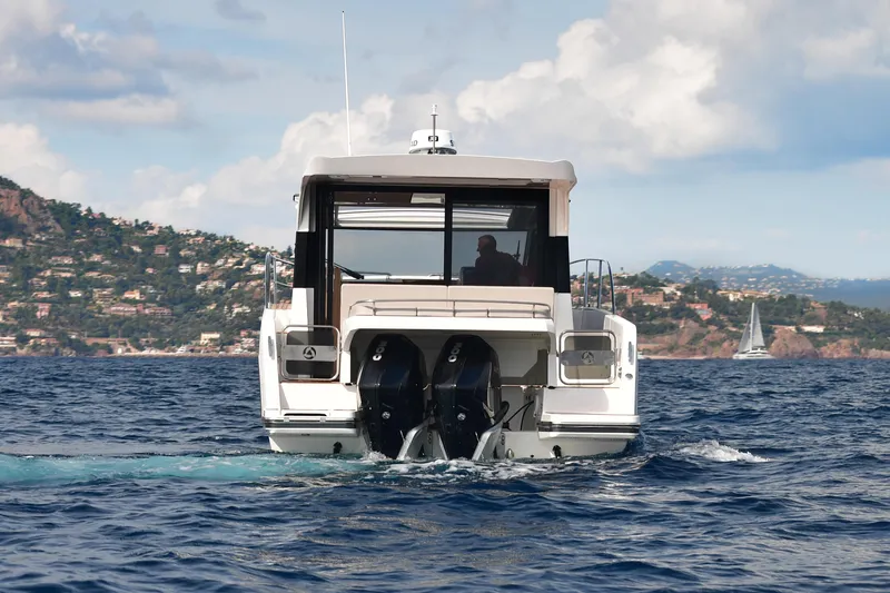  Yacht Photos Pics 2025 Skamander Monaco Coupe yacht cruising on open water with scenic coastal backdrop.