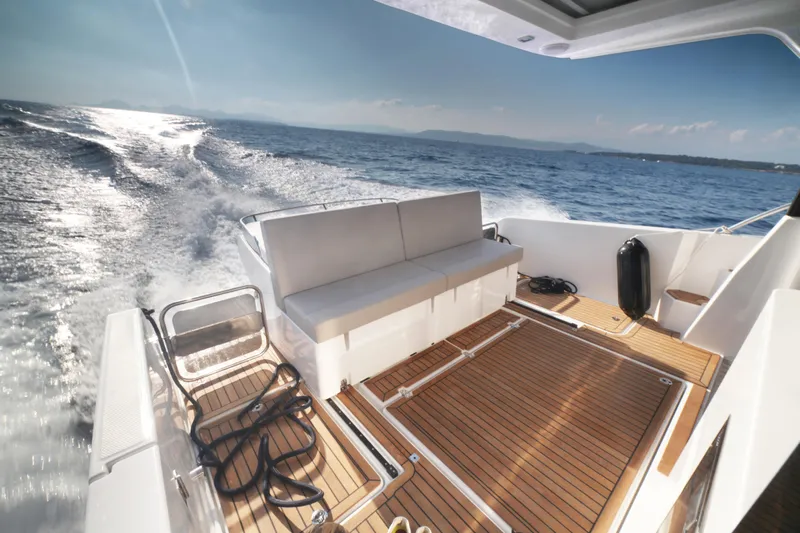  Yacht Photos Pics 2025 Skamander Monaco Coupe yacht with teak deck, cruising on open water.