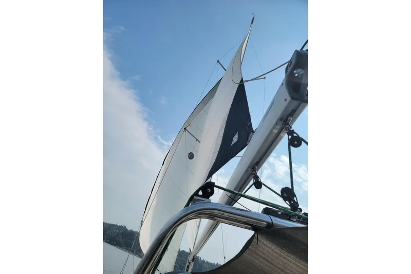  Yacht Photos Pics Sailing on a 2008 Hunter 49 yacht with white sails against a clear blue sky.