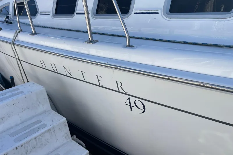  Yacht Photos Pics 2008 Hunter 49 sailboat side view with windows and railing.