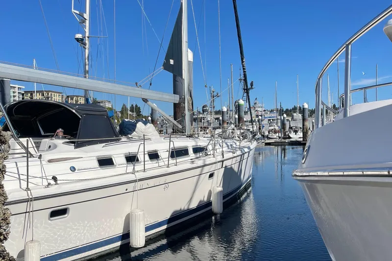  Yacht Photos Pics 2008 Hunter 49 sailboat docked in a marina under clear blue skies.
