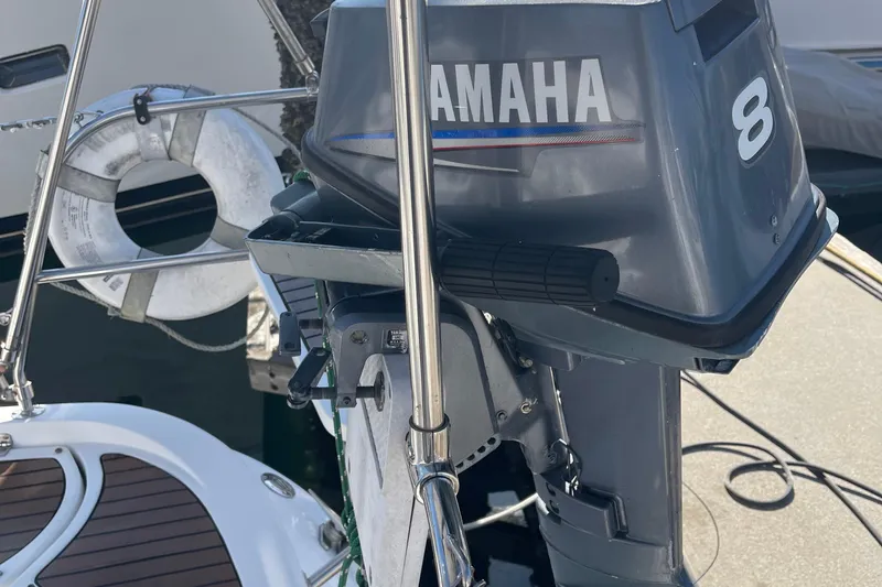  Yacht Photos Pics Yamaha 8 outboard motor on a 2008 Hunter 49 sailboat, docked with a lifebuoy nearby.