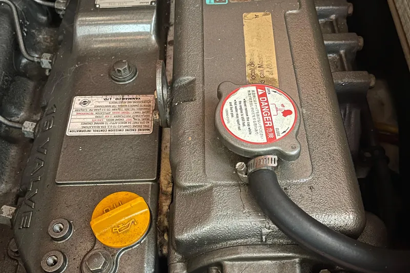  Yacht Photos Pics Engine components of a 2008 Hunter 49, featuring warning labels and a yellow oil cap.