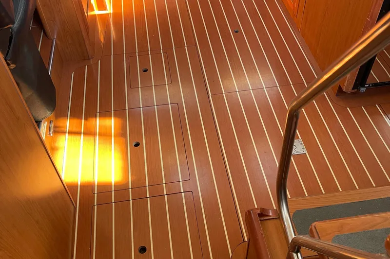  Yacht Photos Pics Teak interior flooring of 2008 Hunter 49 yacht, featuring sleek design and warm lighting.