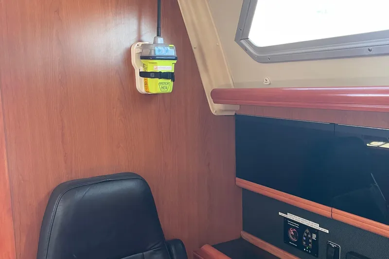  Yacht Photos Pics Interior of a 2008 Hunter 49 yacht with wooden paneling and navigation equipment.