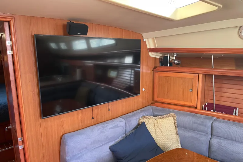  Yacht Photos Pics Interior of 2008 Hunter 49 yacht with TV, wooden cabinetry, and cushioned seating.
