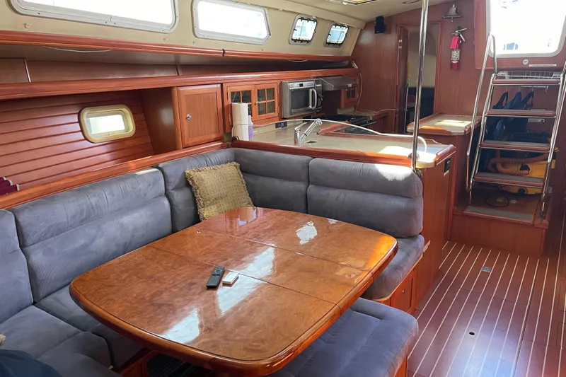  Yacht Photos Pics Luxurious interior of 2008 Hunter 49 yacht with dining area and kitchen.