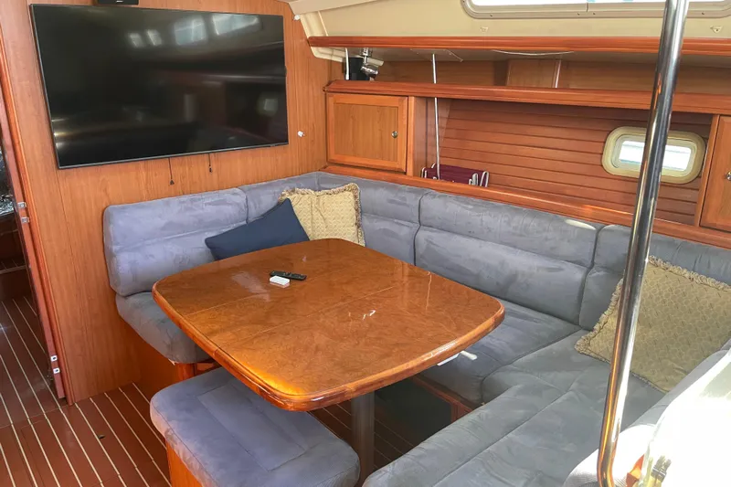  Yacht Photos Pics Interior of 2008 Hunter 49 yacht with cozy seating and wooden table.