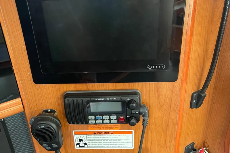  Yacht Photos Pics Control panel of a 2008 Hunter 49 yacht with VHF marine radio and display screen.