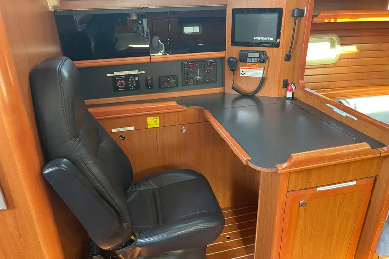  Yacht Photos Pics Navigation station in 2008 Hunter 49 yacht with control panel and leather chair.