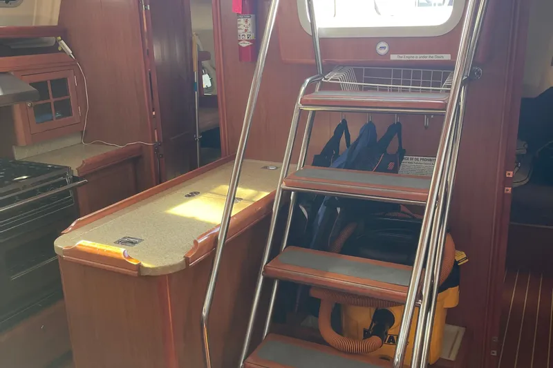  Yacht Photos Pics Interior of a 2008 Hunter 49 yacht with stairs and kitchen area.