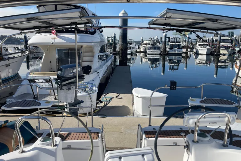  Yacht Photos Pics Marina view with 2008 Hunter 49 sailboat, surrounded by yachts and calm water reflections.