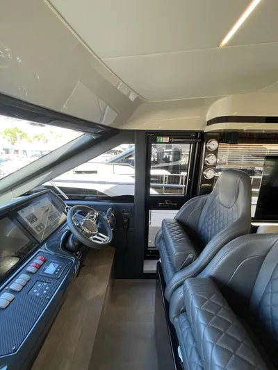  Yacht Photos Pics Interior of 2019 Absolute 62 Fly yacht with modern helm and luxurious seating.