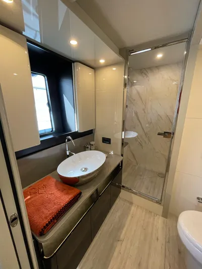  Yacht Photos Pics Luxurious bathroom on 2019 Absolute 62 Fly yacht with modern fixtures and elegant design.