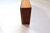 Close-up of a wooden block on a white surface, related to a 1996 Custom Catamaran.