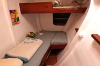 Cozy cabin interior of 1996 Custom Catamaran 60', featuring bunk beds and colorful decor.