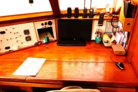 Navigation desk on 1996 Custom Catamaran 60', featuring electronics and organized workspace.