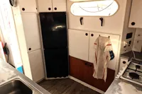 Kitchen area of a 1996 Custom Catamaran 60', featuring cabinets and appliances.
