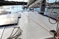1996 Custom CATAMARAN 60' deck with solar panels and ropes in a marina setting.