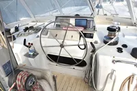 Steering wheel and controls of a 1996 Custom Catamaran 60' yacht cockpit.