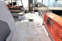 Deck view of a 1996 Custom Catamaran 60', featuring seating and safety equipment.