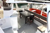 Spacious deck of 1996 Custom CATAMARAN 60' with seating and table.