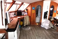 Interior of 1996 Custom Catamaran 60', featuring wood paneling and navigation equipment.