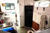 Interior of 1996 Custom Catamaran 60' kitchen with sink, cabinets, and appliances.