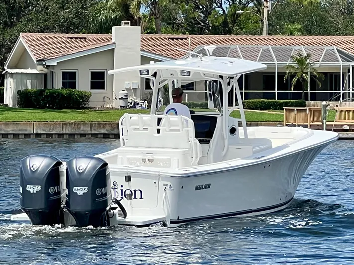 Redemption Yacht Photos Pics 2012 Regulator 34SS boat with dual outboard engines on a calm waterway.