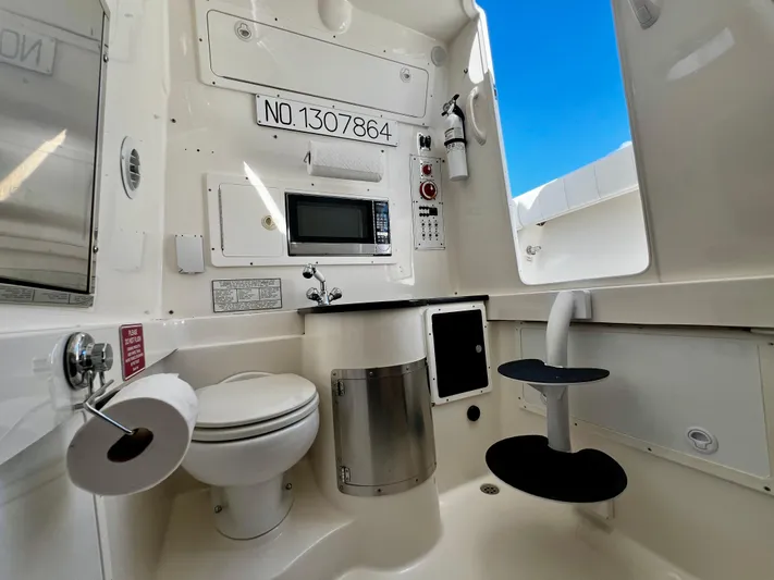 Redemption Yacht Photos Pics Interior of 2012 Regulator 34SS boat featuring a compact bathroom with toilet and sink.