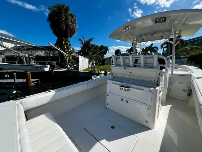 Redemption Yacht Photos Pics 2012 Regulator 34SS boat with spacious deck and seating, docked under clear blue sky.