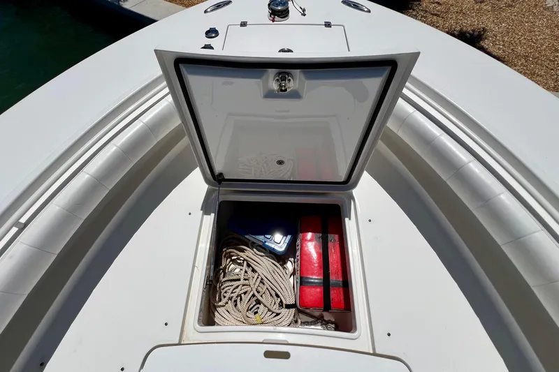 Redemption Yacht Photos Pics Open storage compartment on 2012 Regulator 34SS boat, containing ropes and red containers.