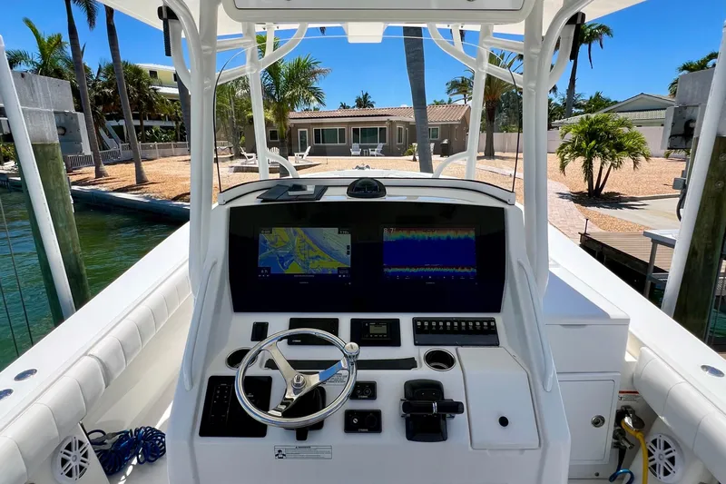 Redemption Yacht Photos Pics 2012 Regulator 34SS boat helm with dual displays, steering wheel, and controls.